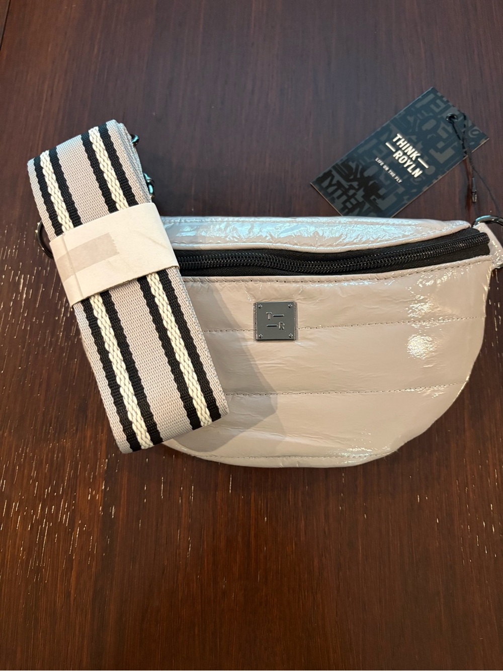THINK ROYLN Beige Patent Crossbody Belt Bag with Striped Strap